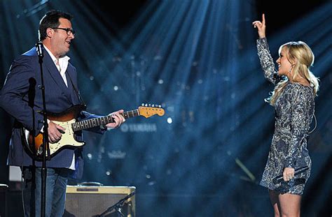 vince gill and carrie underwood how great thou art How does the harmonious blend of gospel music and country music reflect the universal themes of faith and redemption?